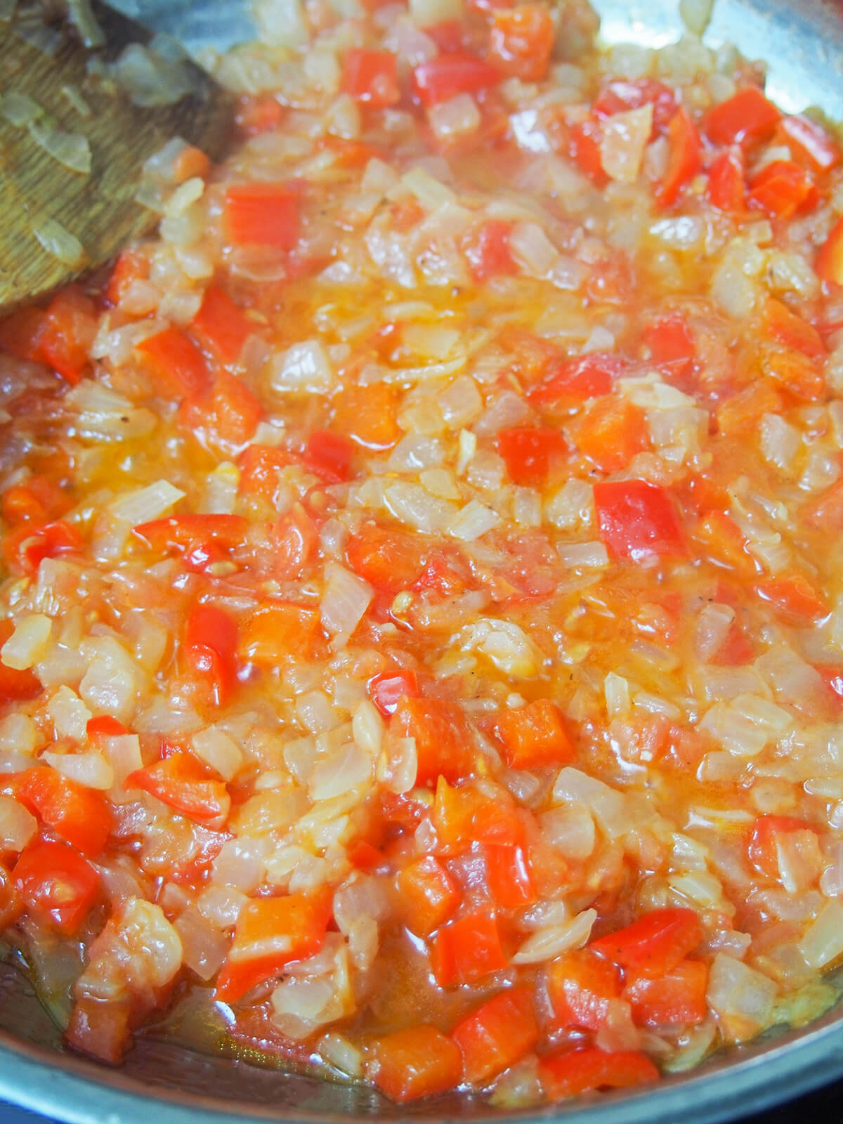 simmering onion, pepper and tomatoes in skillet.
