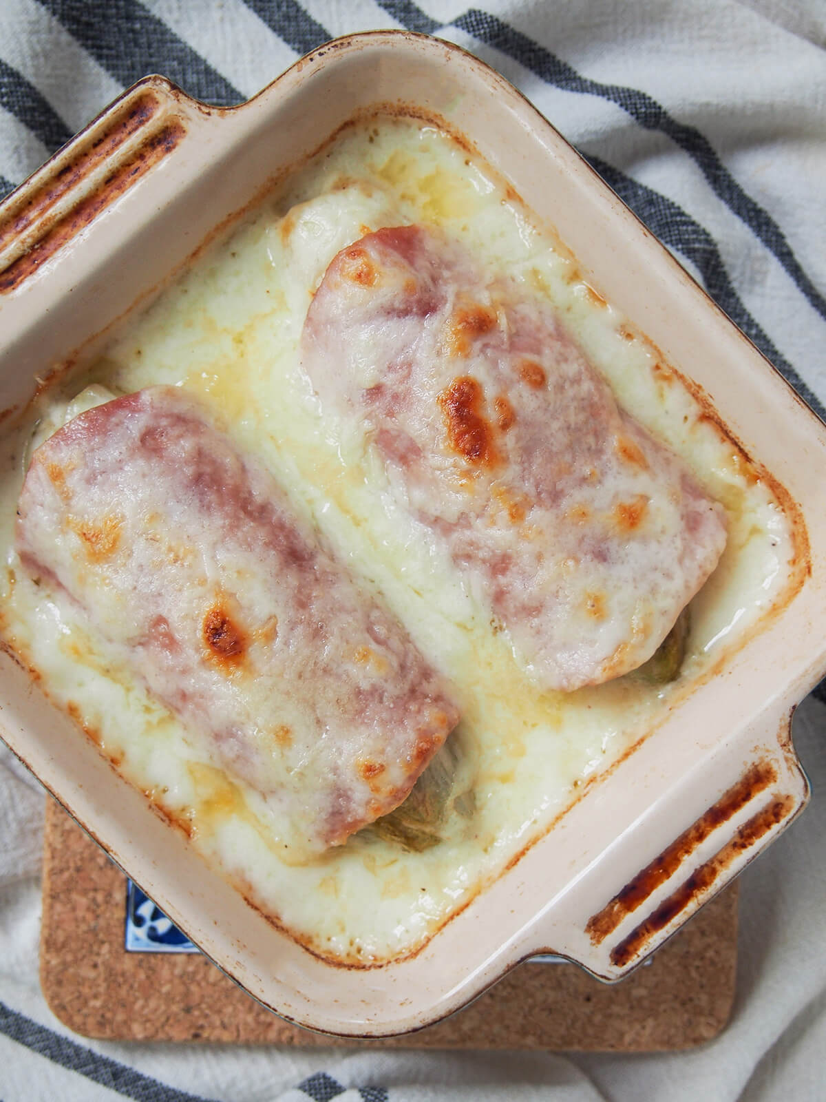 overhead view of dish of endives au jambon (Belgian endive gratin).