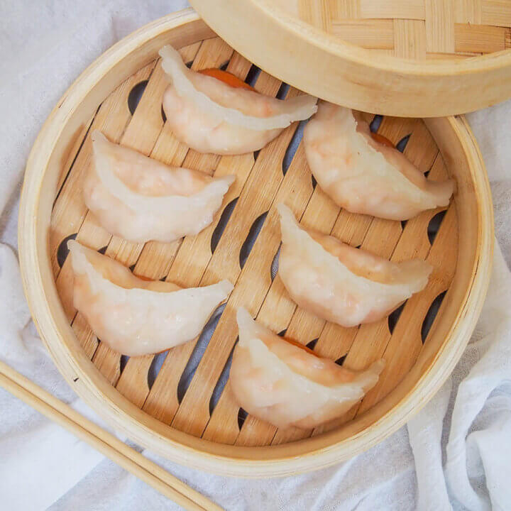 overhead view of har gow dumplings in bamboo steamer.