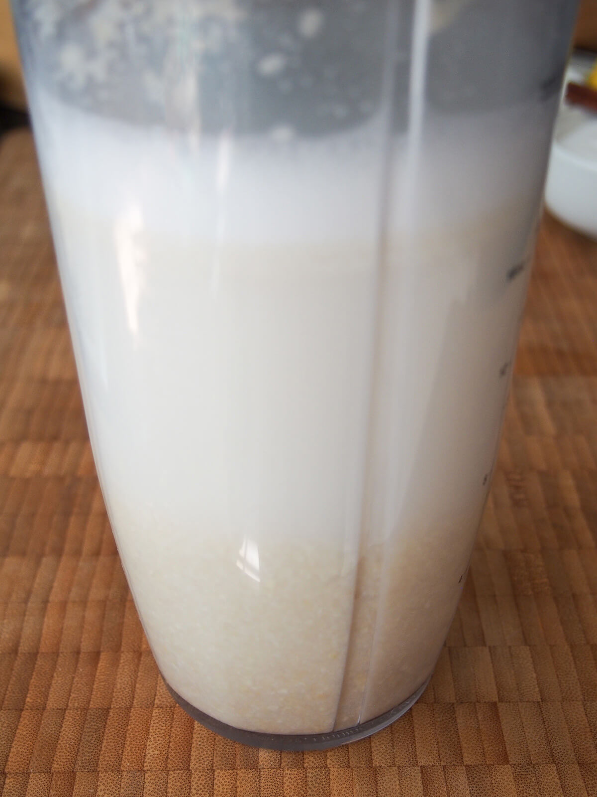 blender showing ground almond and water mixture as it soaks.