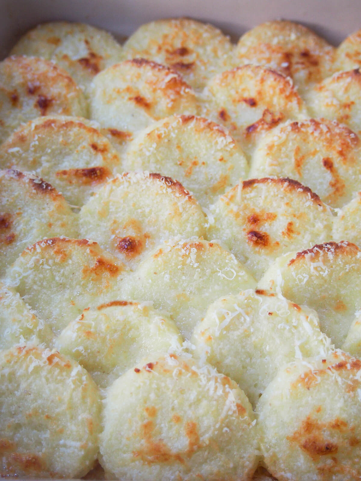 close up view of semolina gnocchi, gnocchi alla Romana
