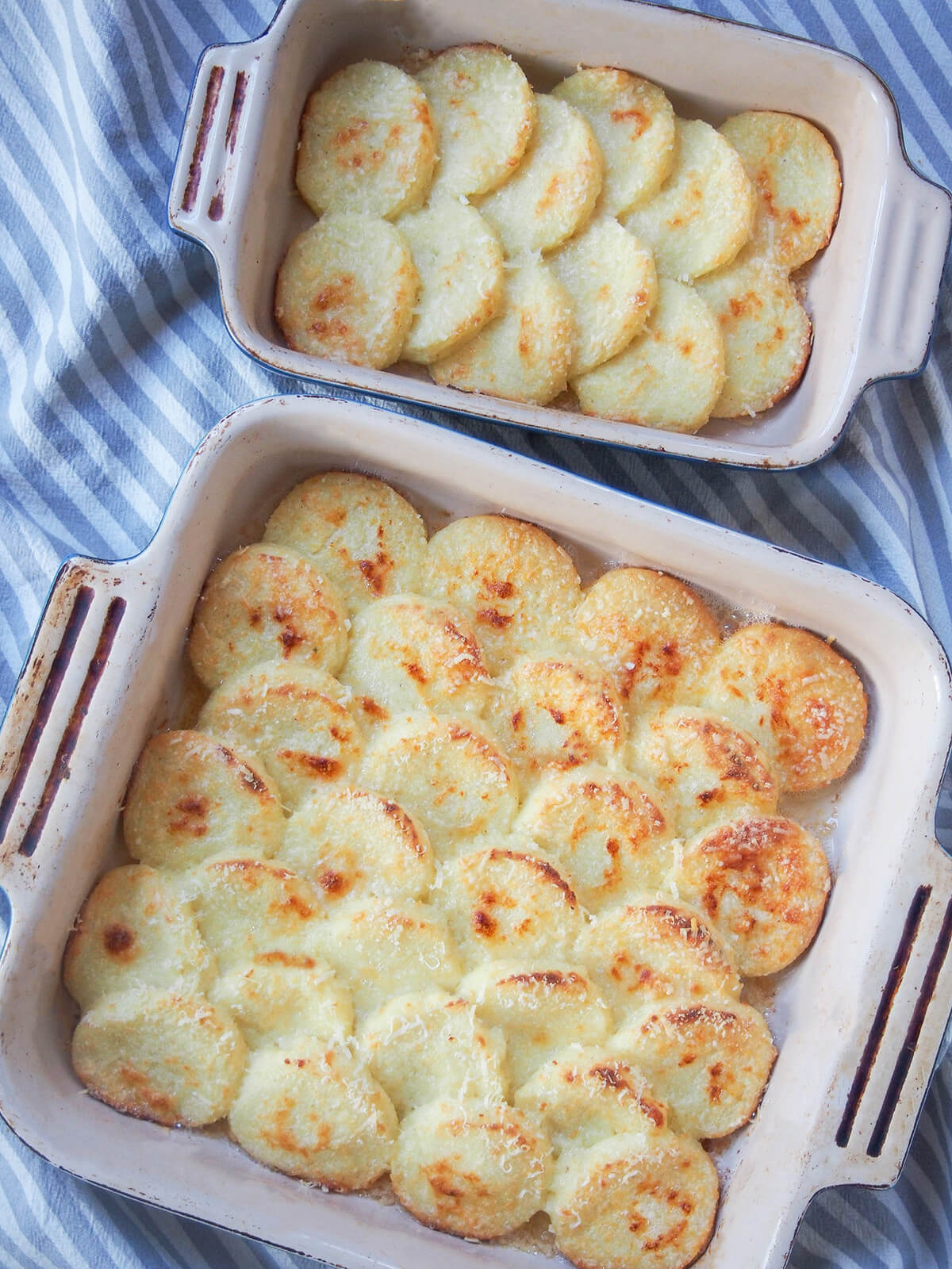 larger and smaller dish of semolina gnocchi, gnocchi alla Romana, from overhead.