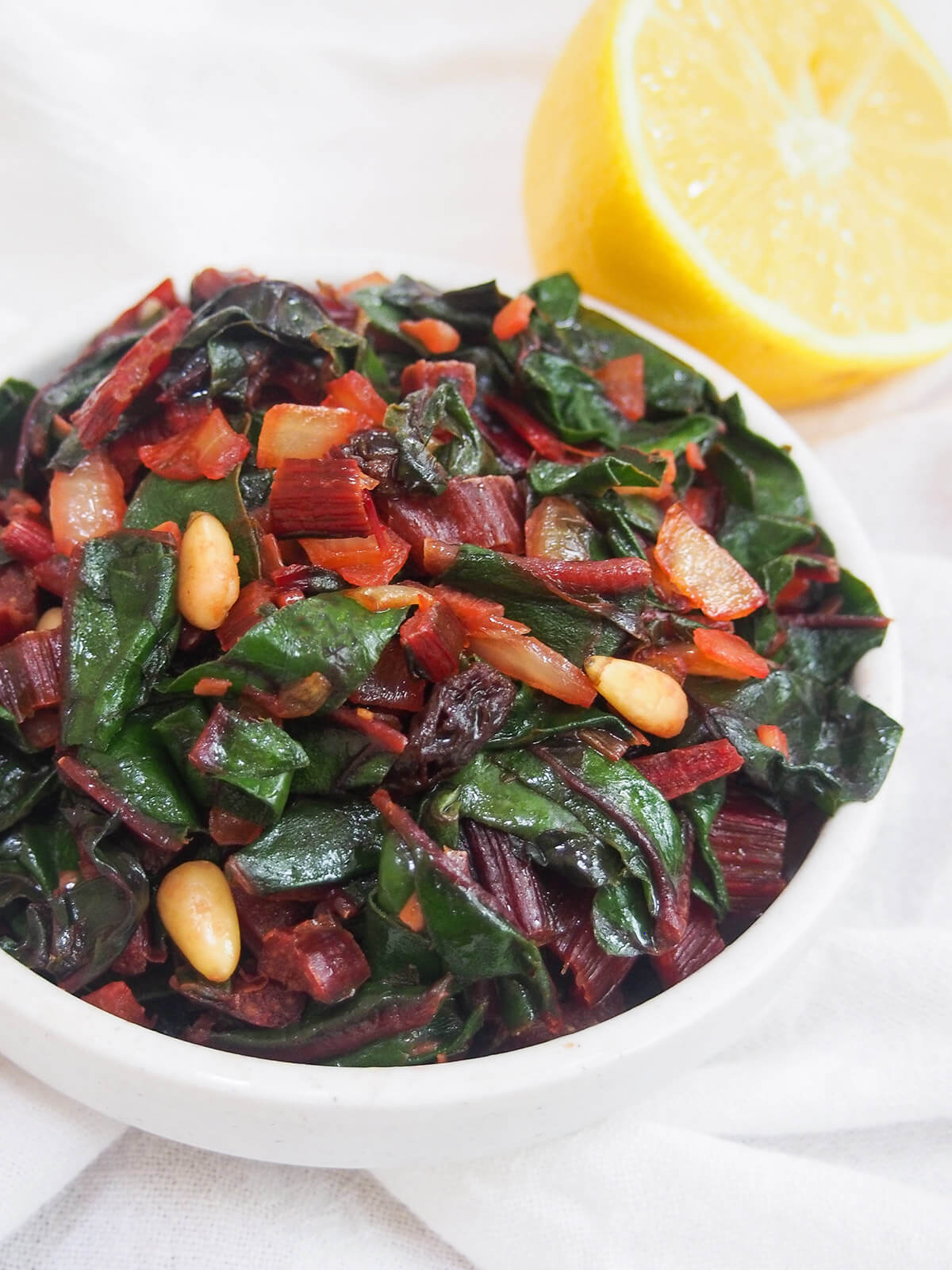 Catalan-style sauteed Swiss chard with raisins and pine nuts bowl of sauteed chard with raisins and pine nuts
