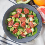 overhead view of a bowl of avocado grapefruit salad.