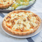caramelized onion and goat cheese tart on small plate.