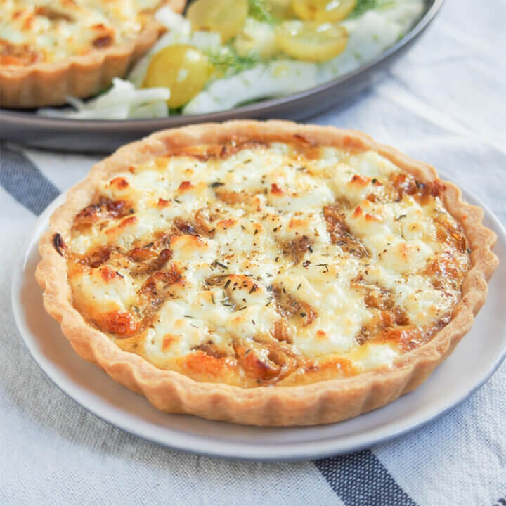 caramelized onion and goat cheese tart on small plate.