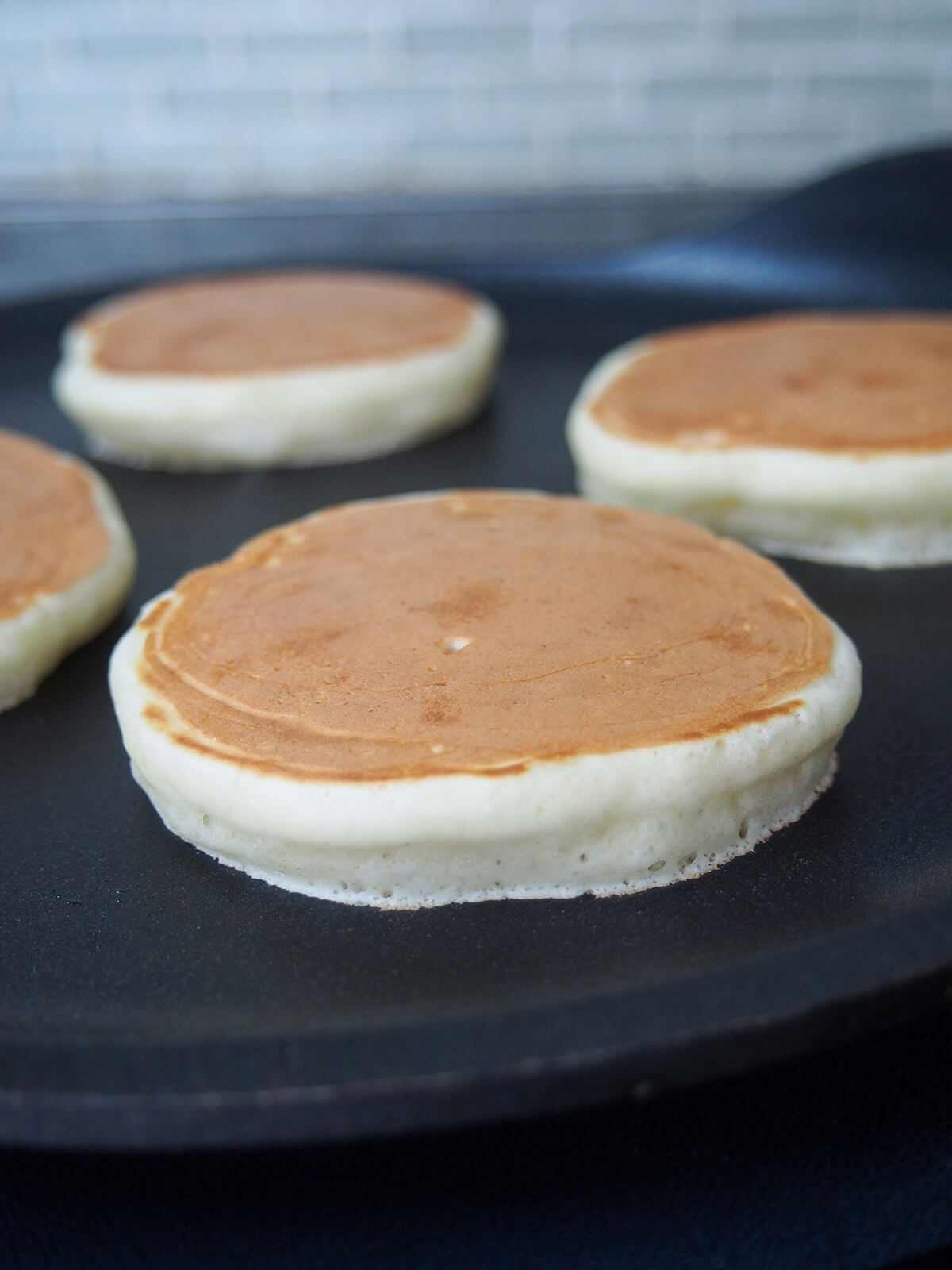 side view of Scotch pancakes cooking showing height of pancake.