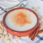 dish of menjarblanc almond pudding with spoon behind.