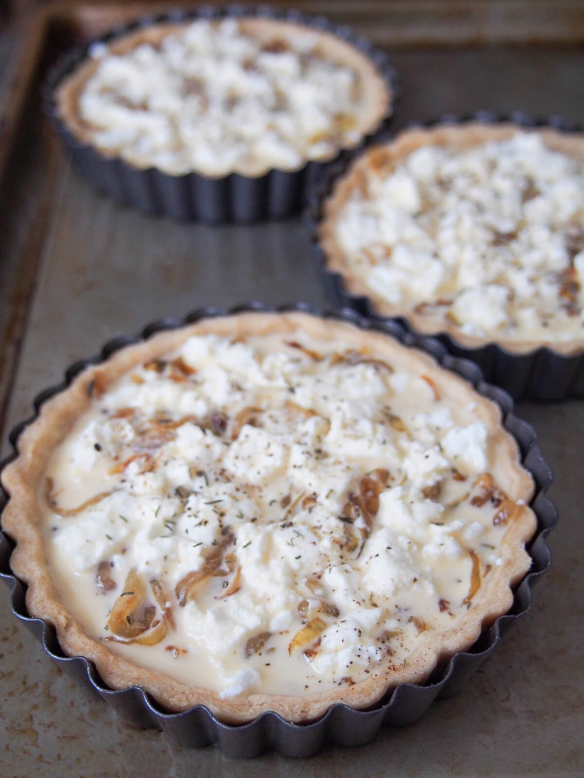 filled caramelized onion and goat cheese tarts before baking.