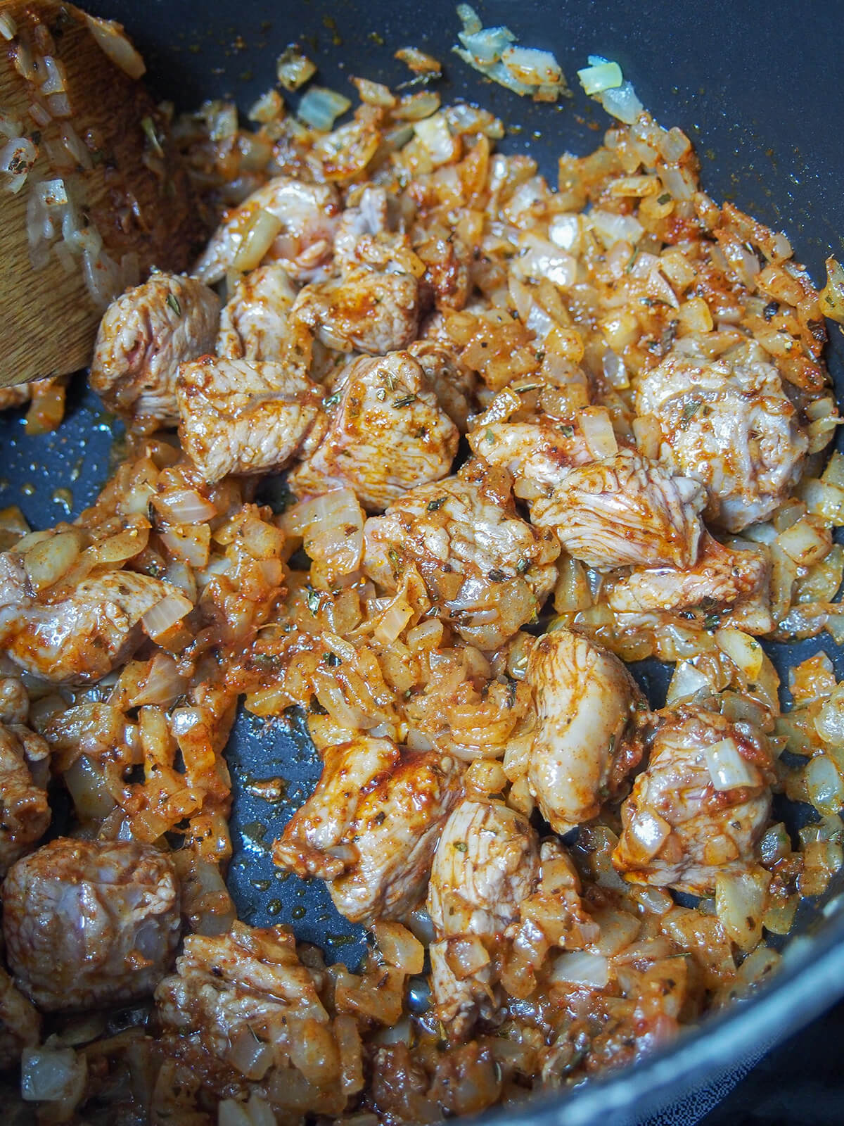 cooking onion and lamb with spices.