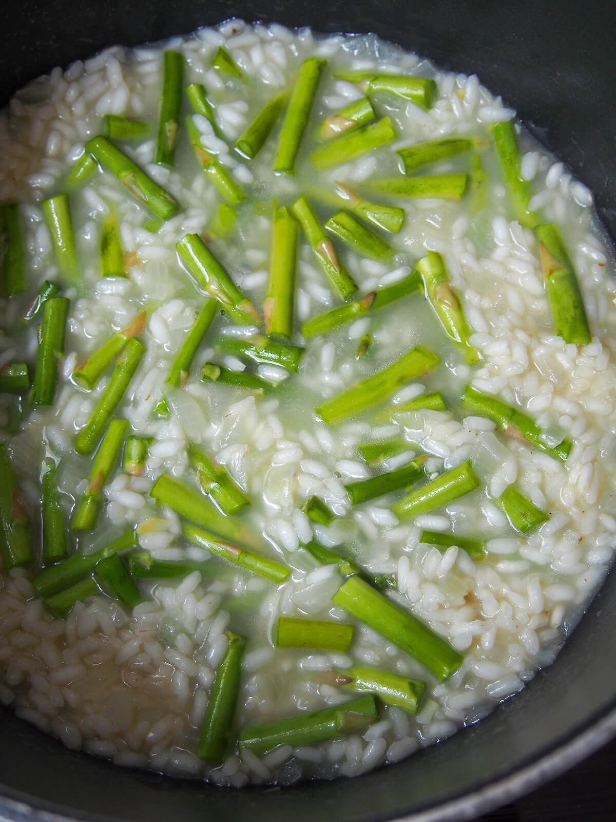 adding asparagus and last of stock to risotto as it cooks.