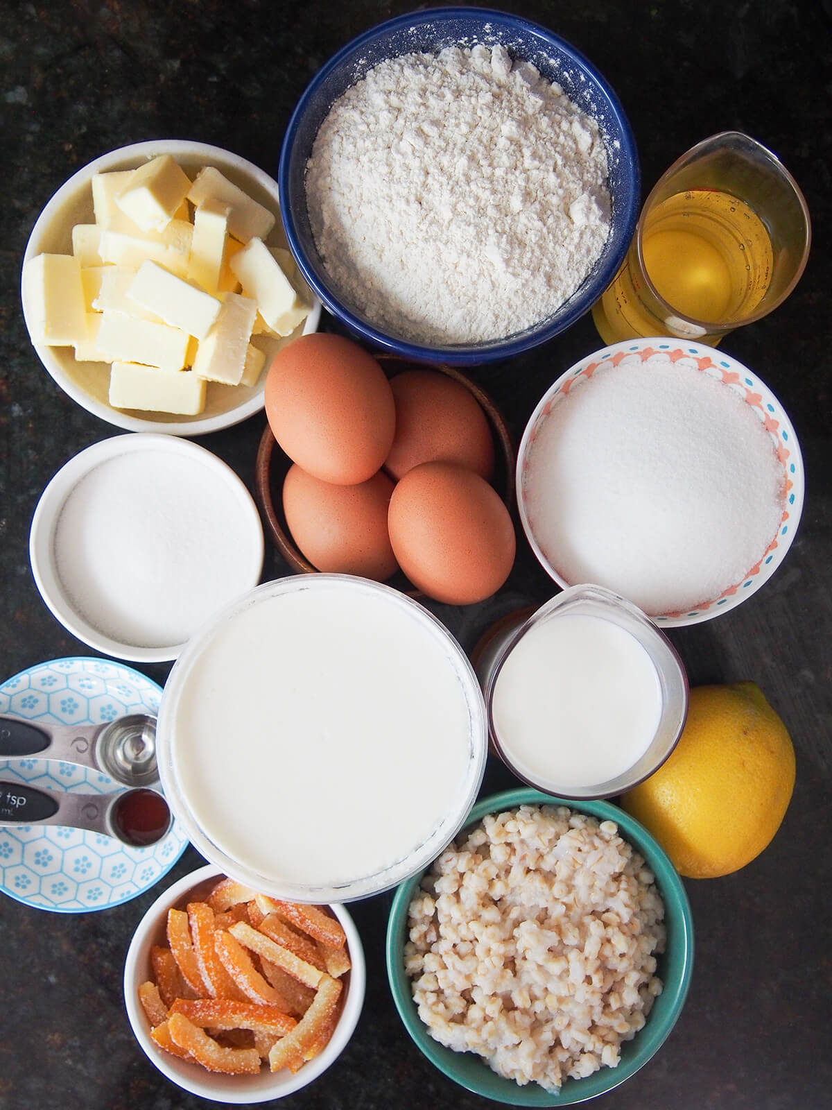 ingredients for pastiera napoletana bowls with flour, sugar, butter, eggs, cooked wheat berries, ricotta and candied orange peel.