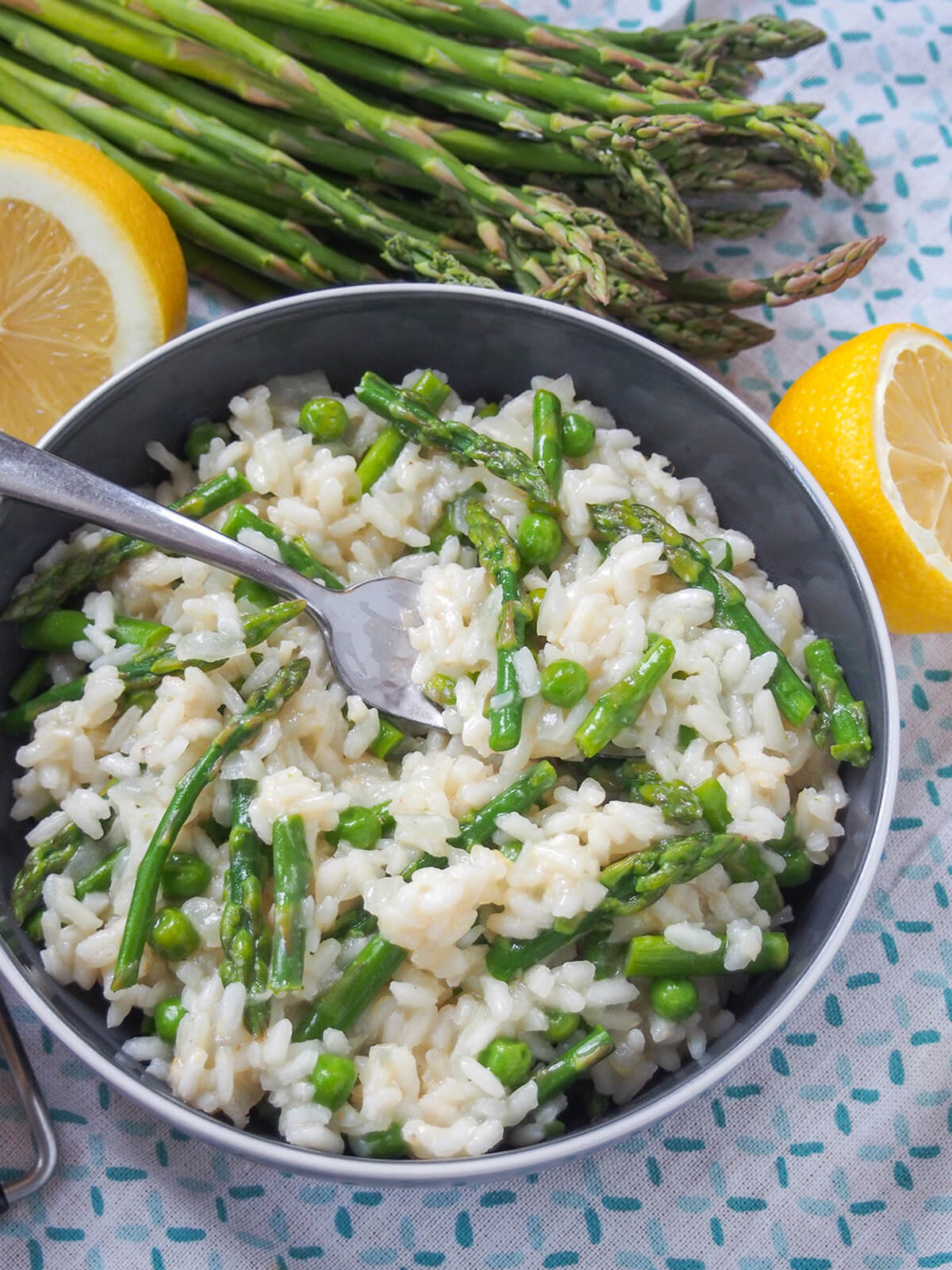 bowl of lemon asparagus risotto with fork in bowl.