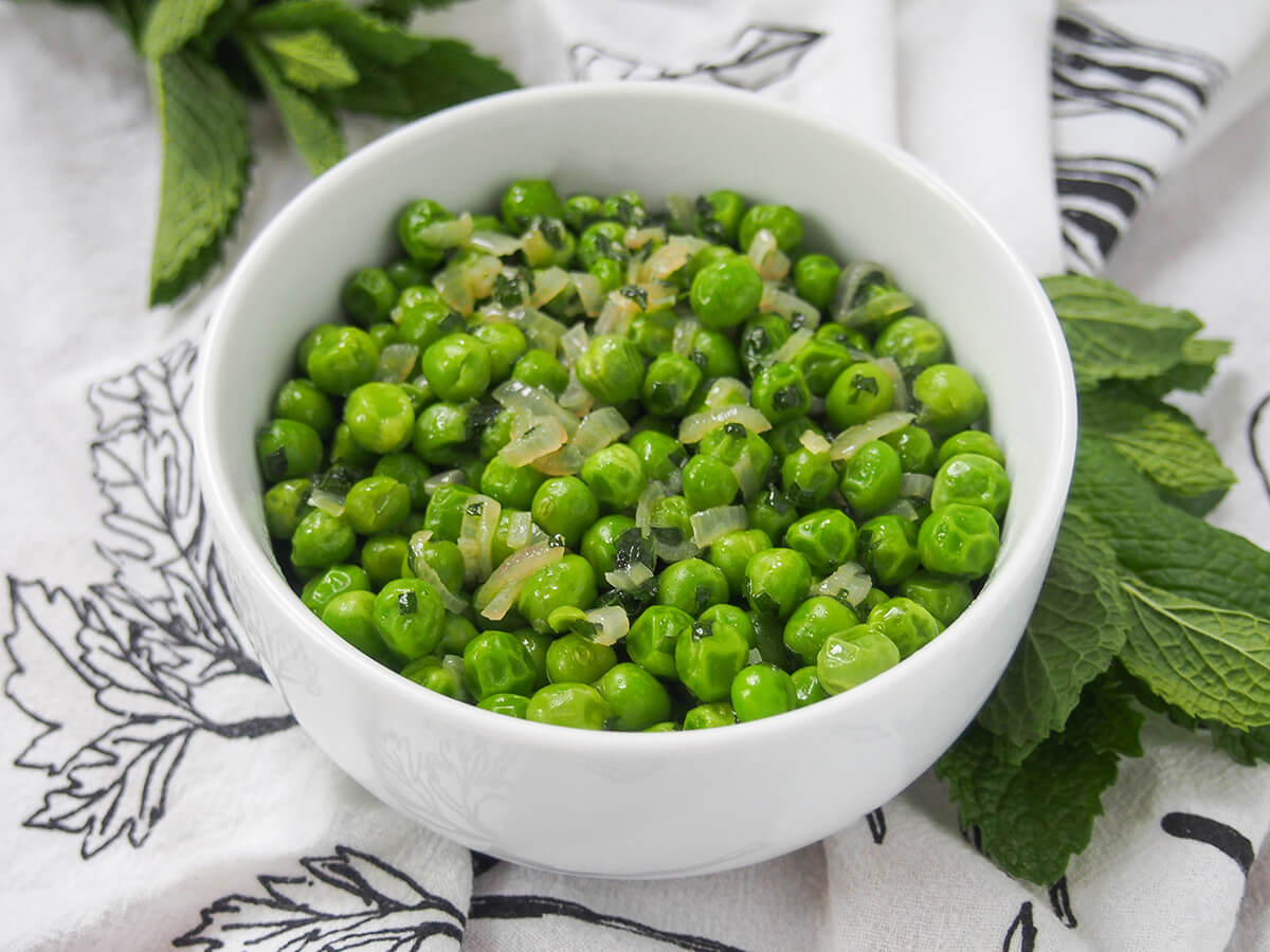 bowl of minted peas viewed from the side.