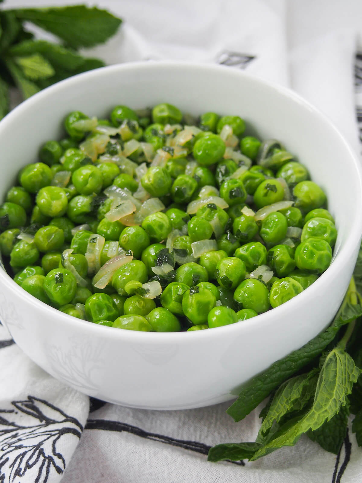 side close view of bowl of minted peas.