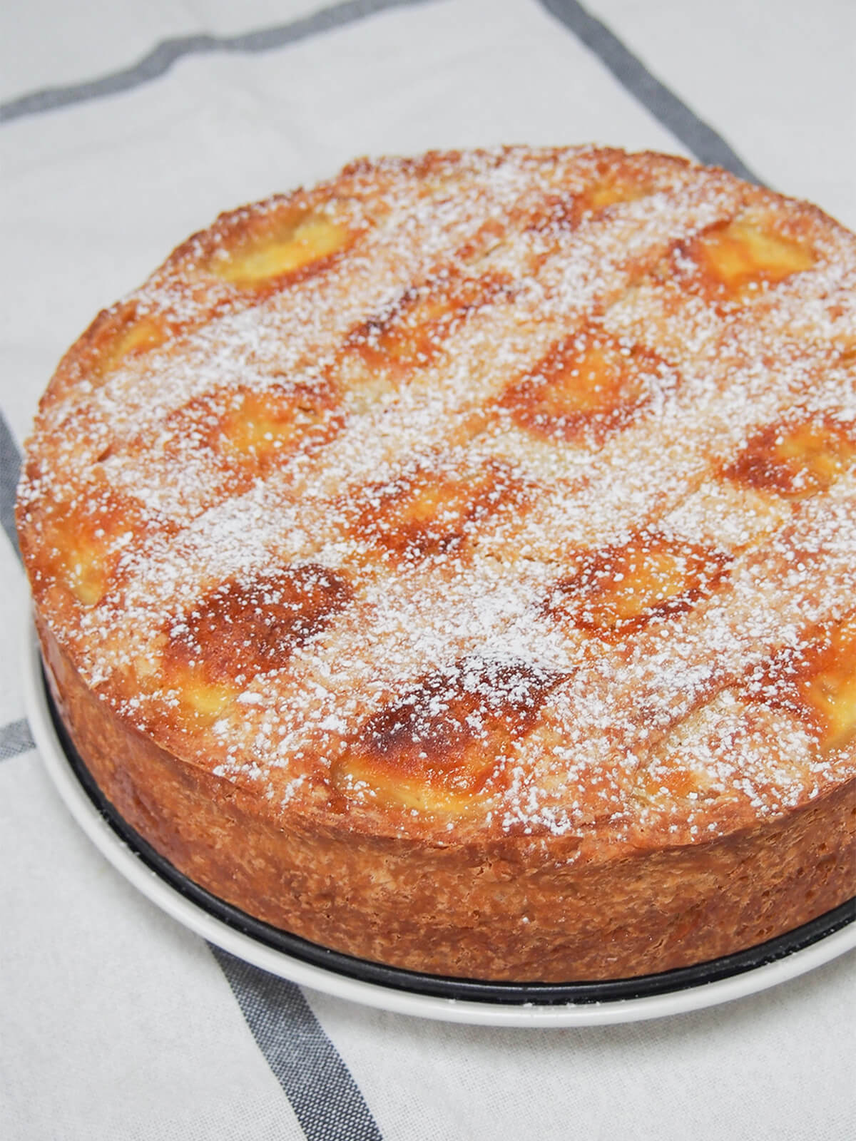 whole pastiera napoletana, an Italian Easter dessert whole pastiera napoletana on plate.