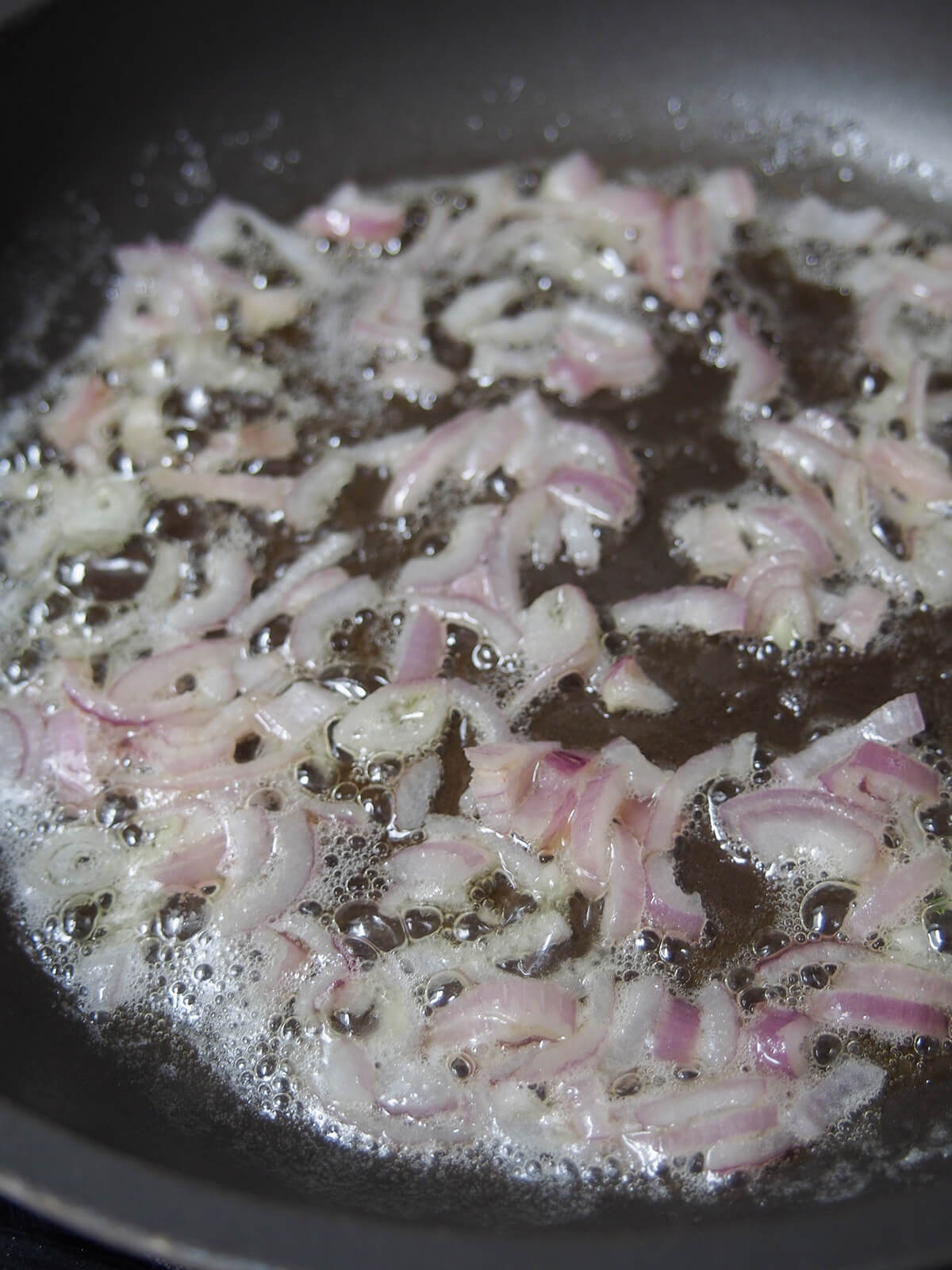 sliced shallot cooking in butter.