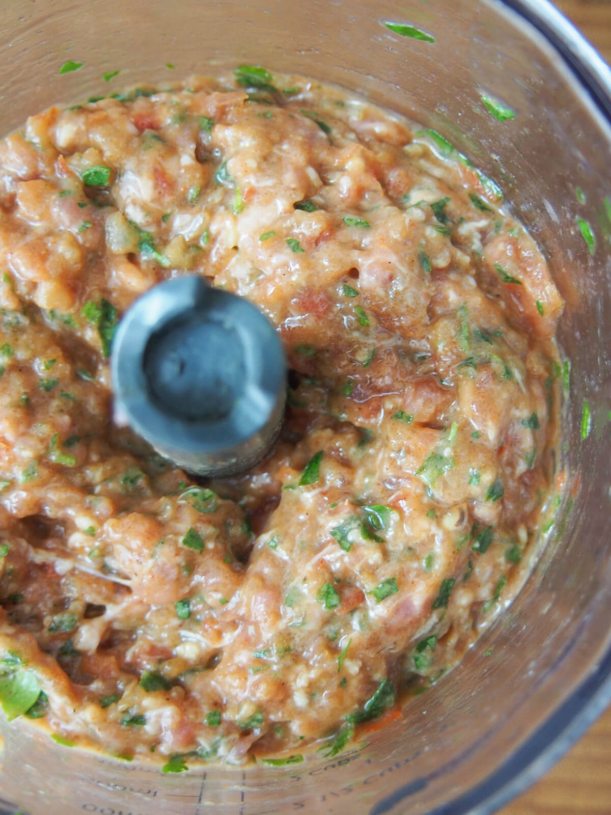 ground lamb, herb, spice and pepper mixture in mini food processor.
