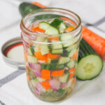 side view of jar of acar timun, Indonesian pickles.