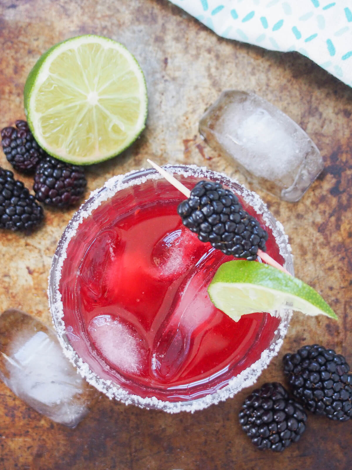overhead view of glass of blackberry margarita.
