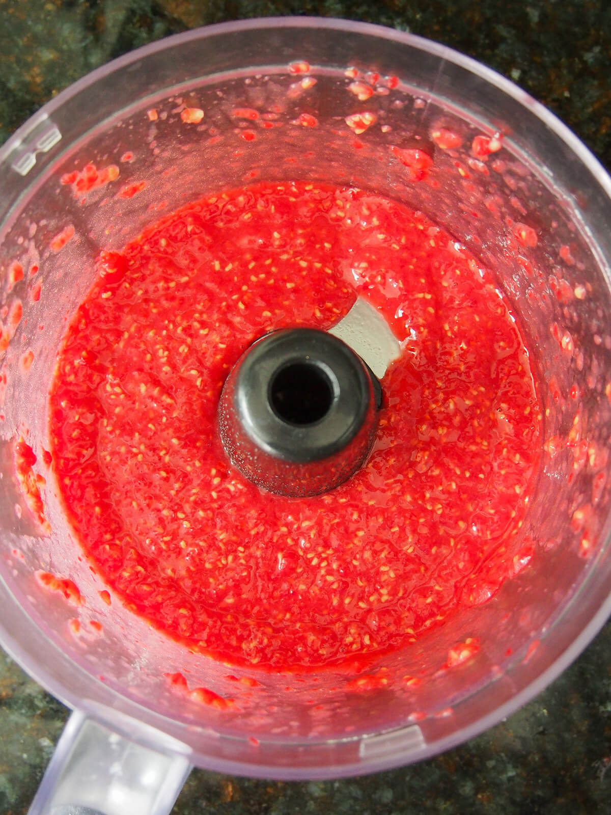 broken up raspberries in food processor.