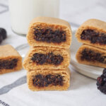 three homemade fig Newtons stacked on top of each other with more behind to side.