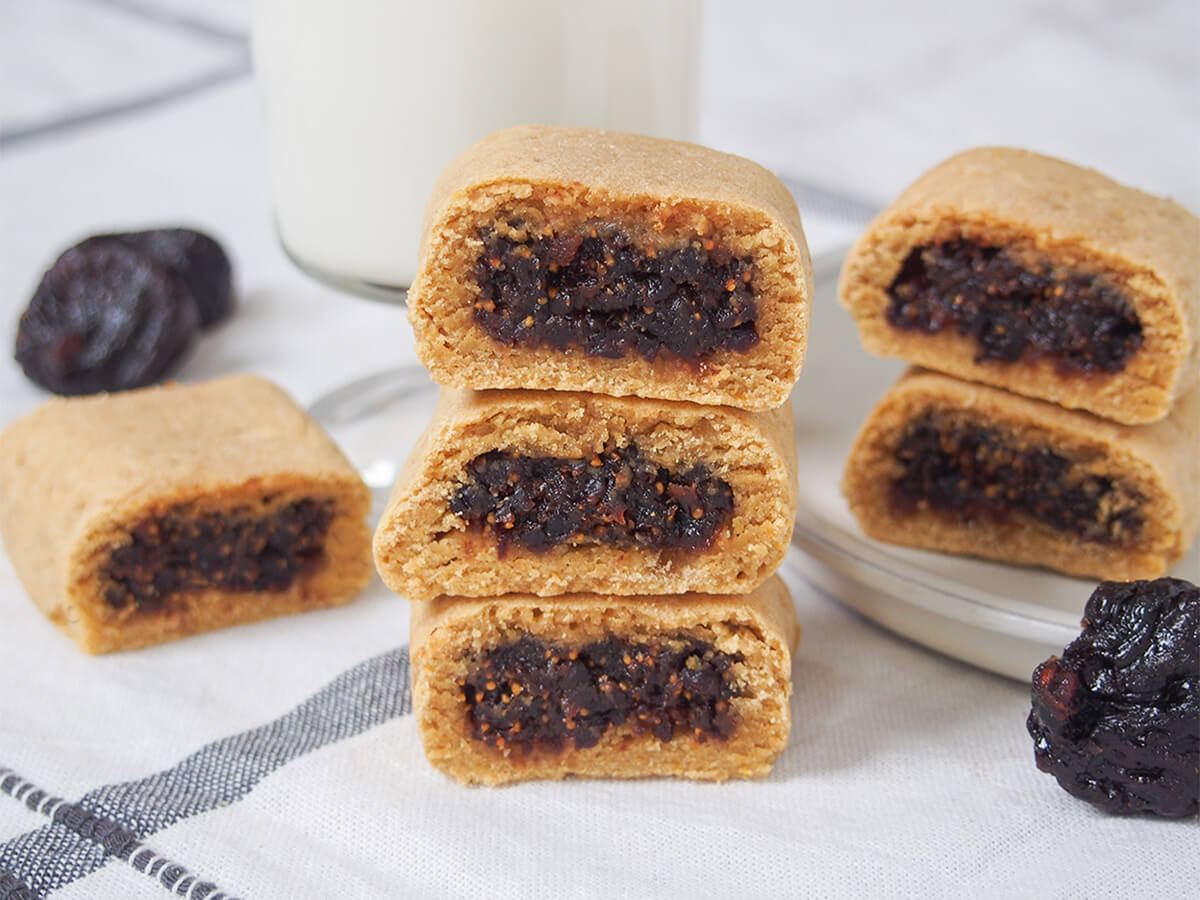 stack of three homemade fig Newtons with one to left and two more to right behind.