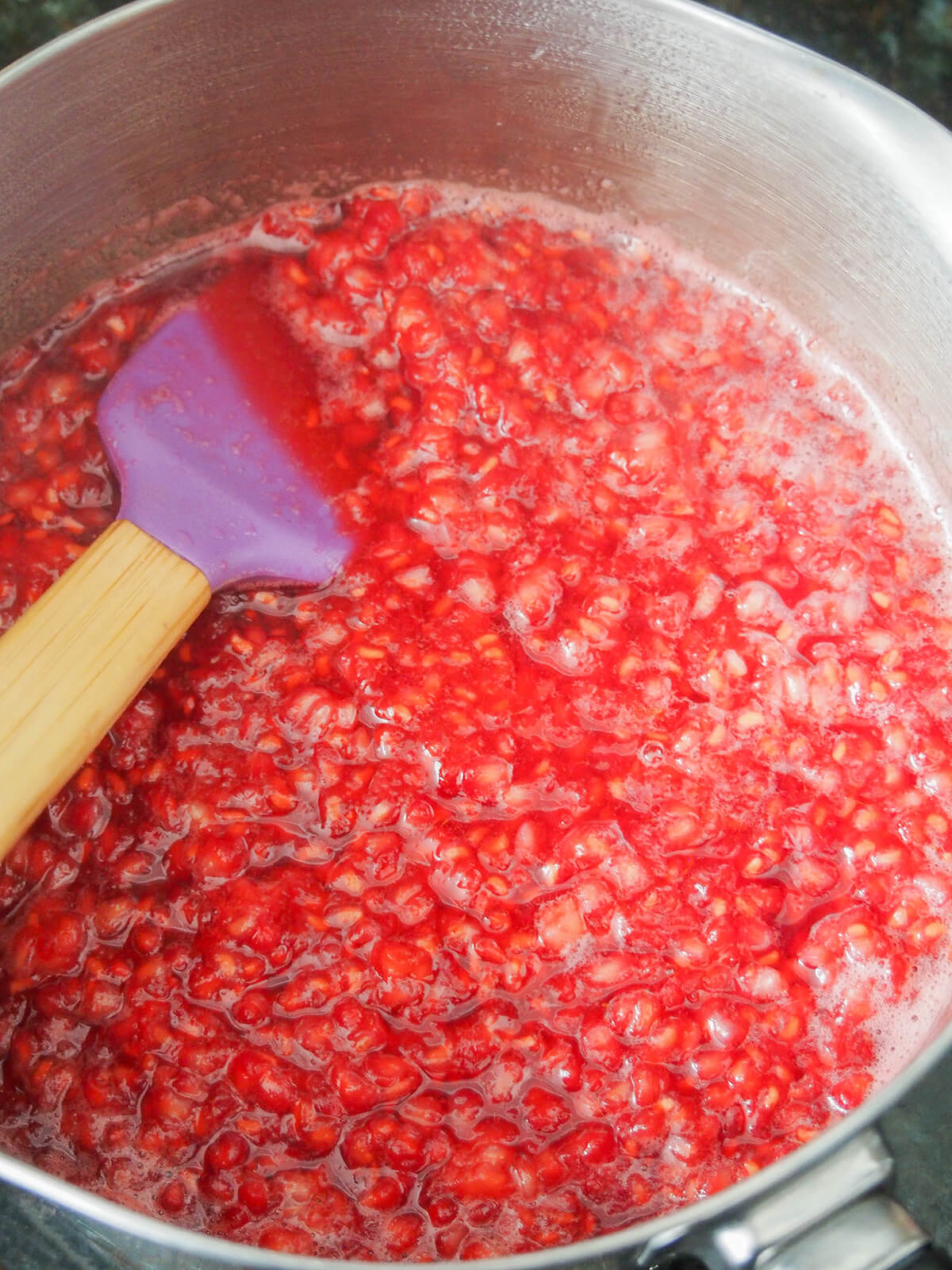 simmering raspberries with a little sugar in a small pan.