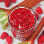 jar of raspberry rhubarb jam viewed from overhead.