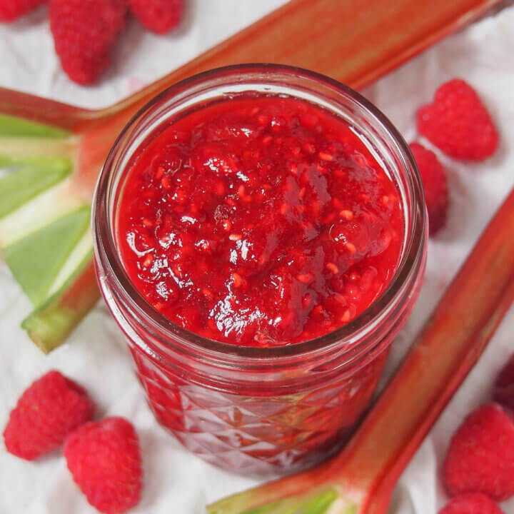 jar of raspberry rhubarb jam viewed from overhead.