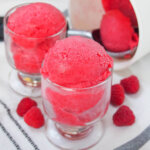 side view of two glasses of raspberry sorbet.