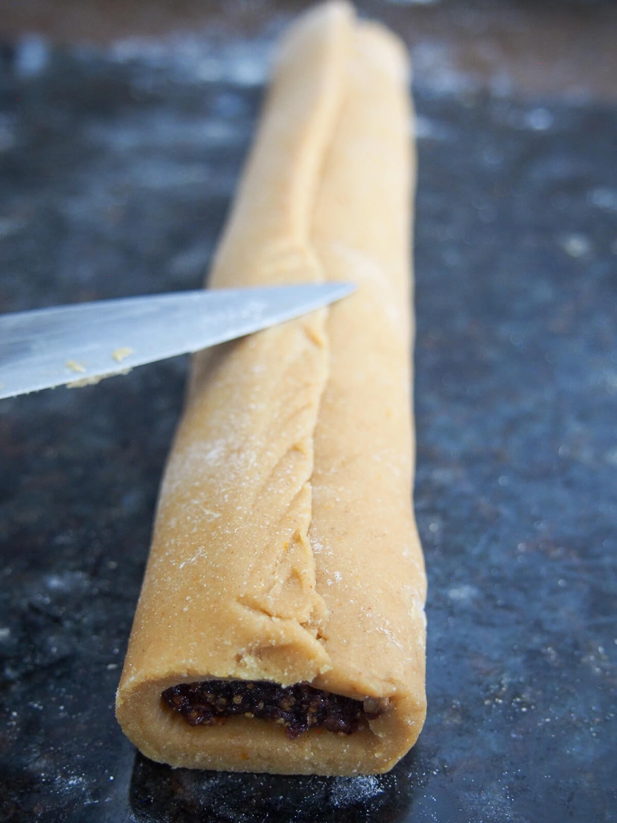 sealing dough along top of cookie roll