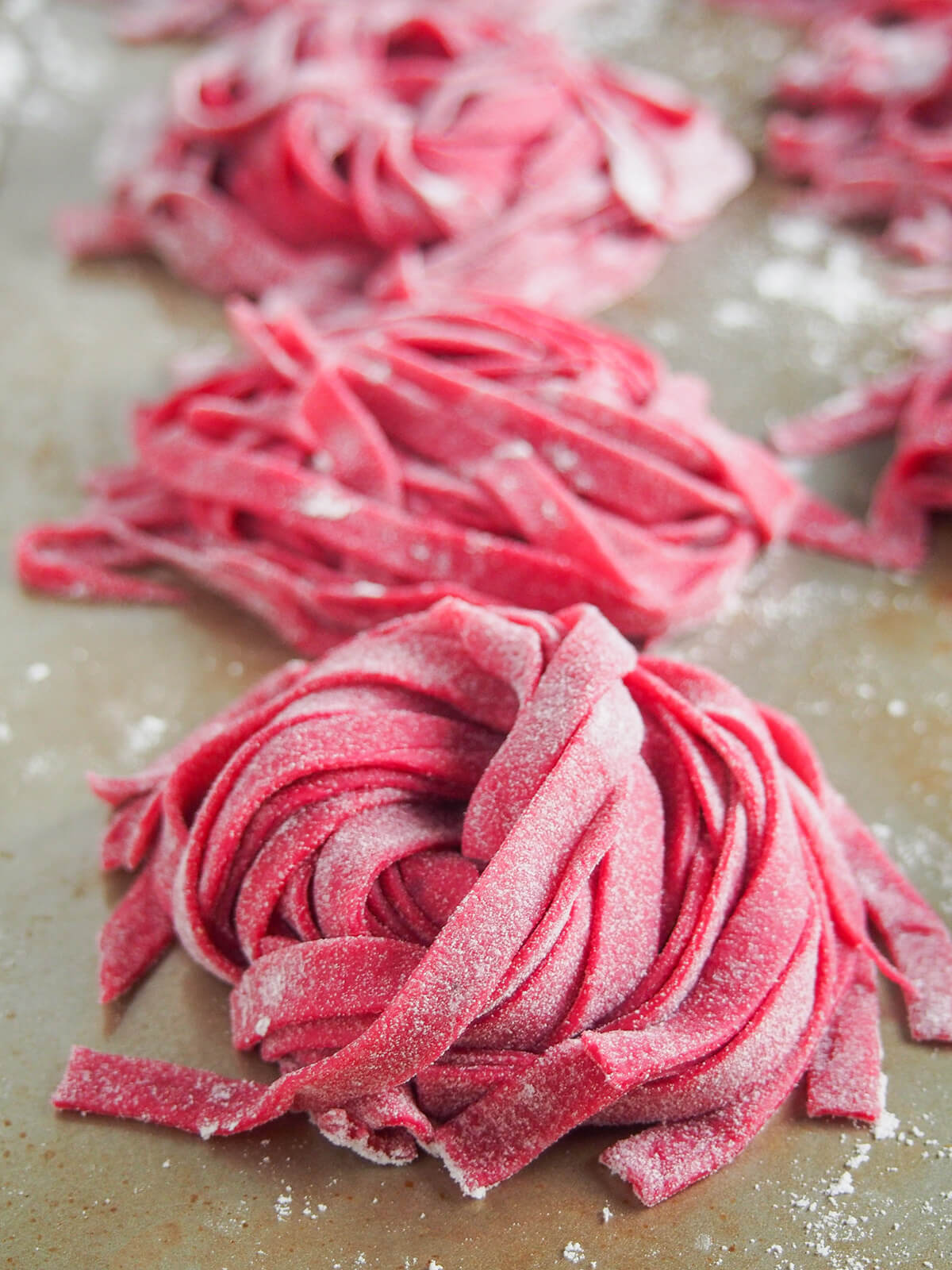stacks of linguini beet pasta dough.