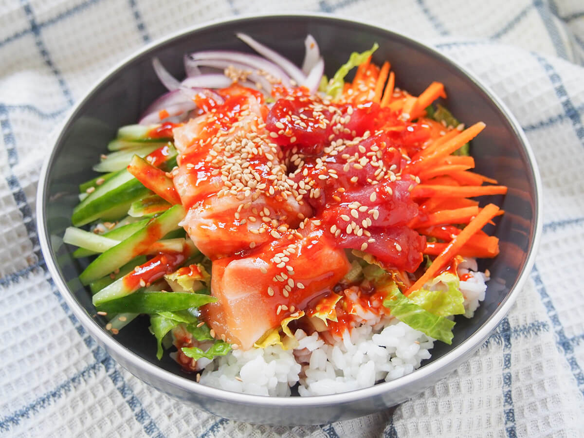 side view of bowl of Korean sashimi rice bowl, hoedeopbap.