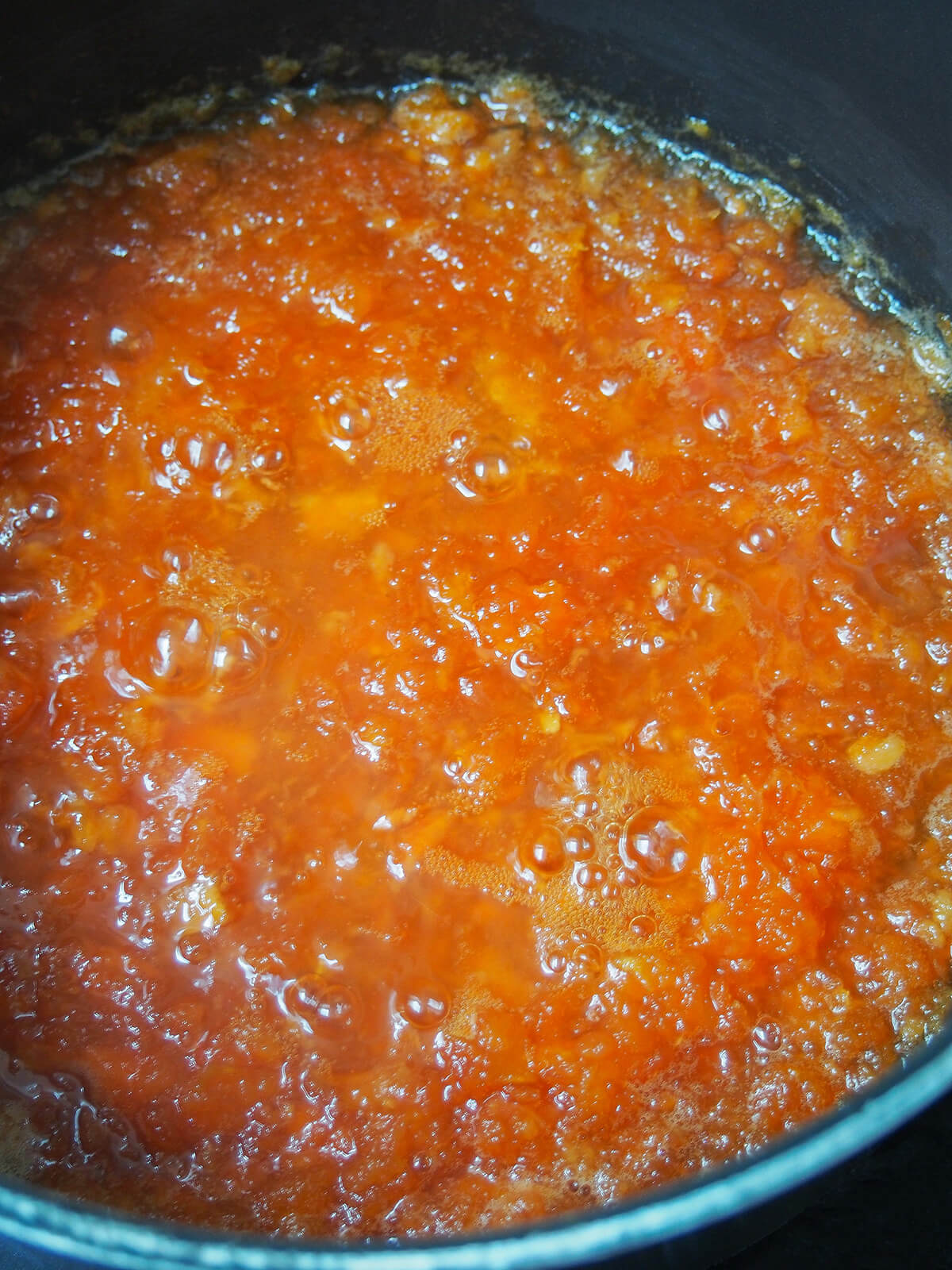 simmering papaya jam simmering papaya jam in pot.