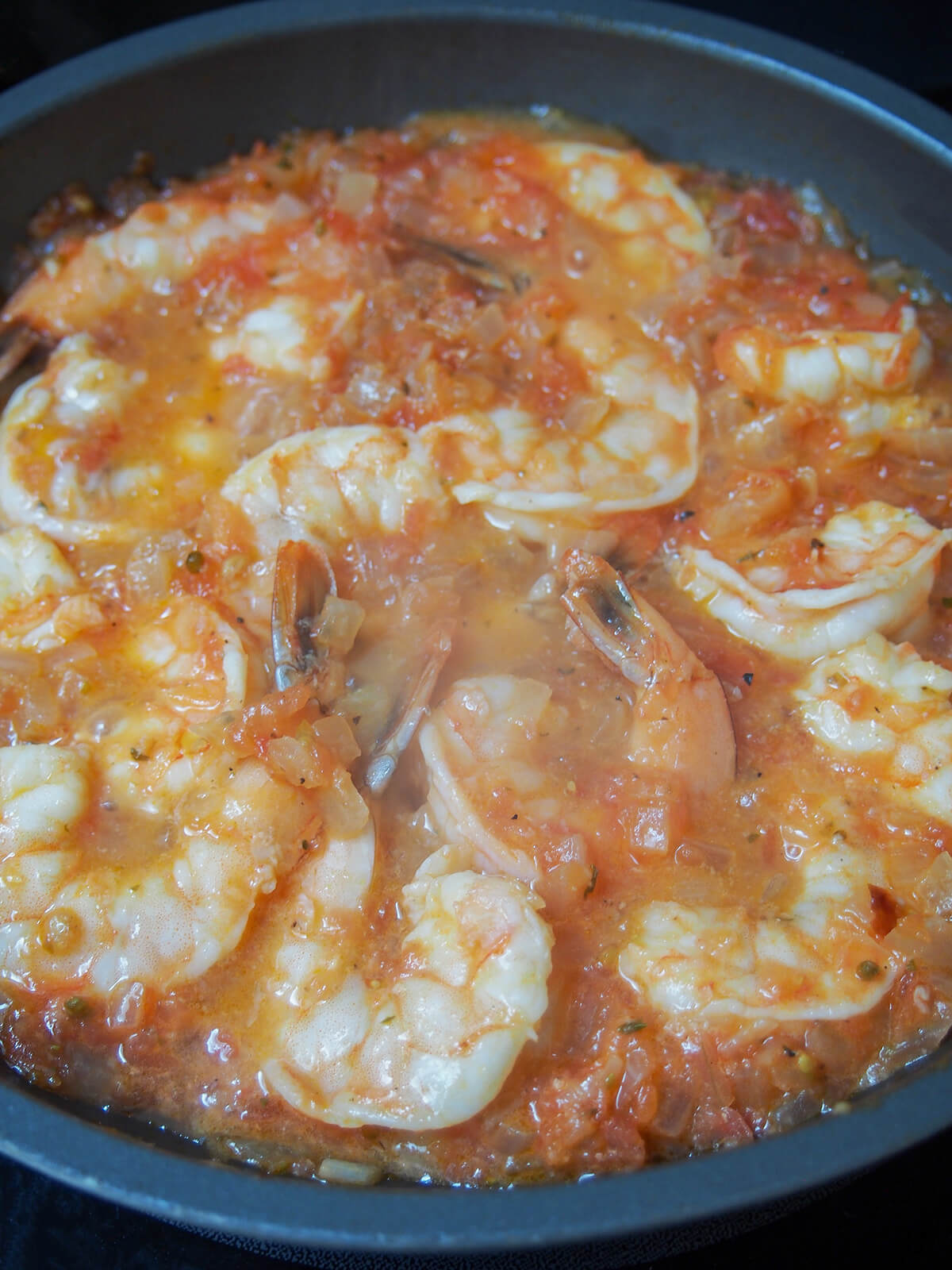 shrimp in tomato sauce with the shrimp cooked through.