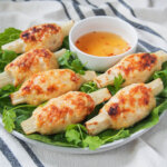 plate of Vietnamese sugarcane shrimp with dipping sauce to back.