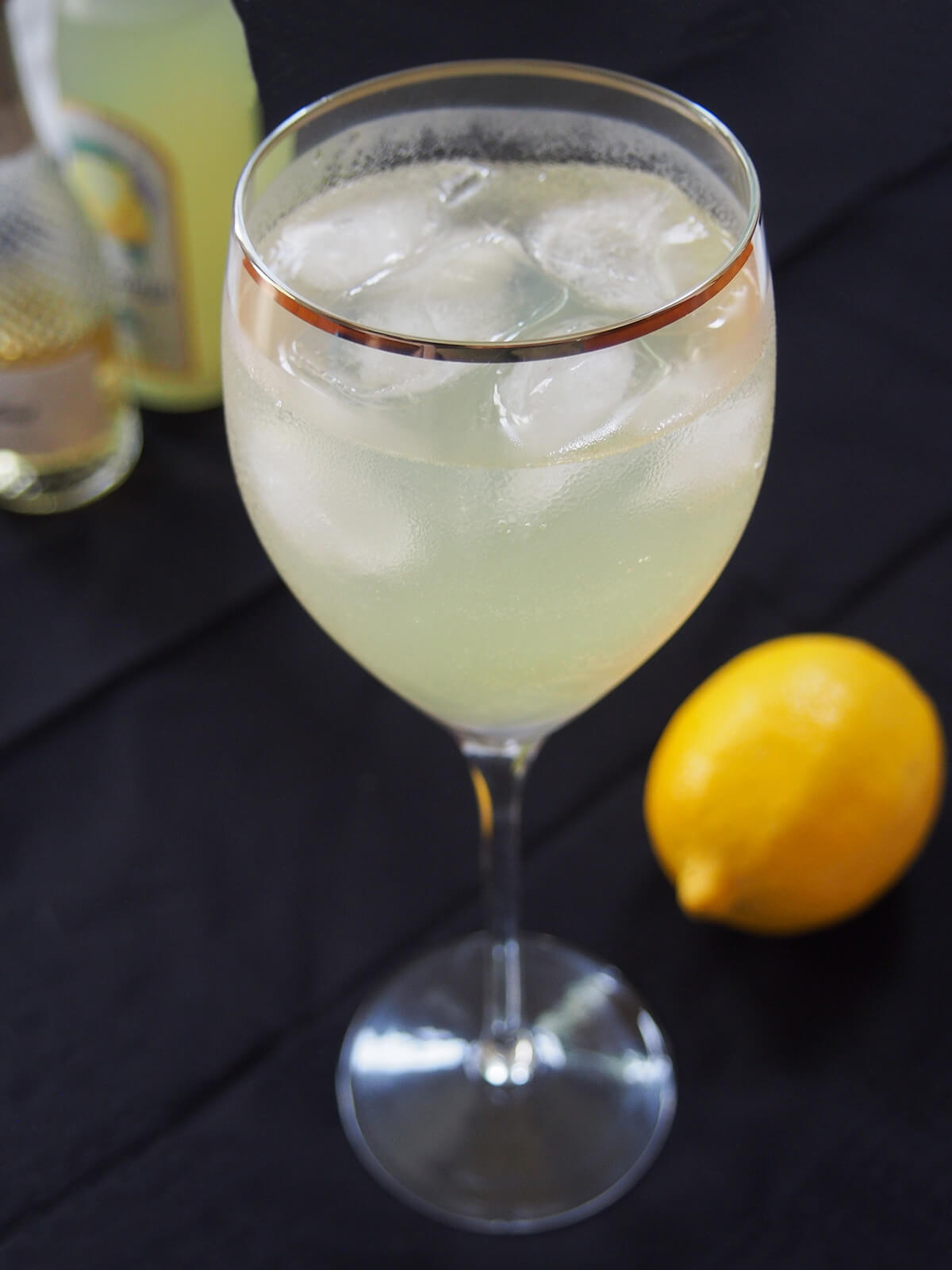 side view of a glass of limoncello spritz.
