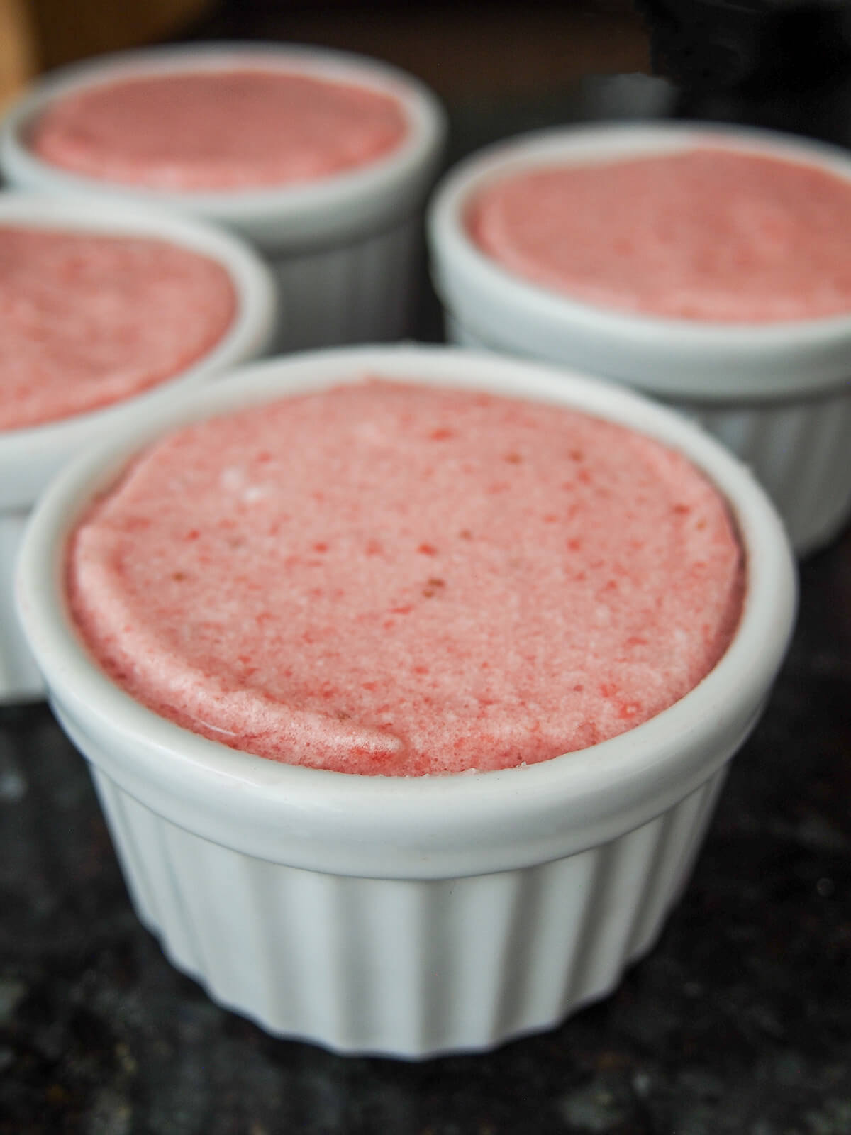 strawberry souffle mixture in dishes before baking.