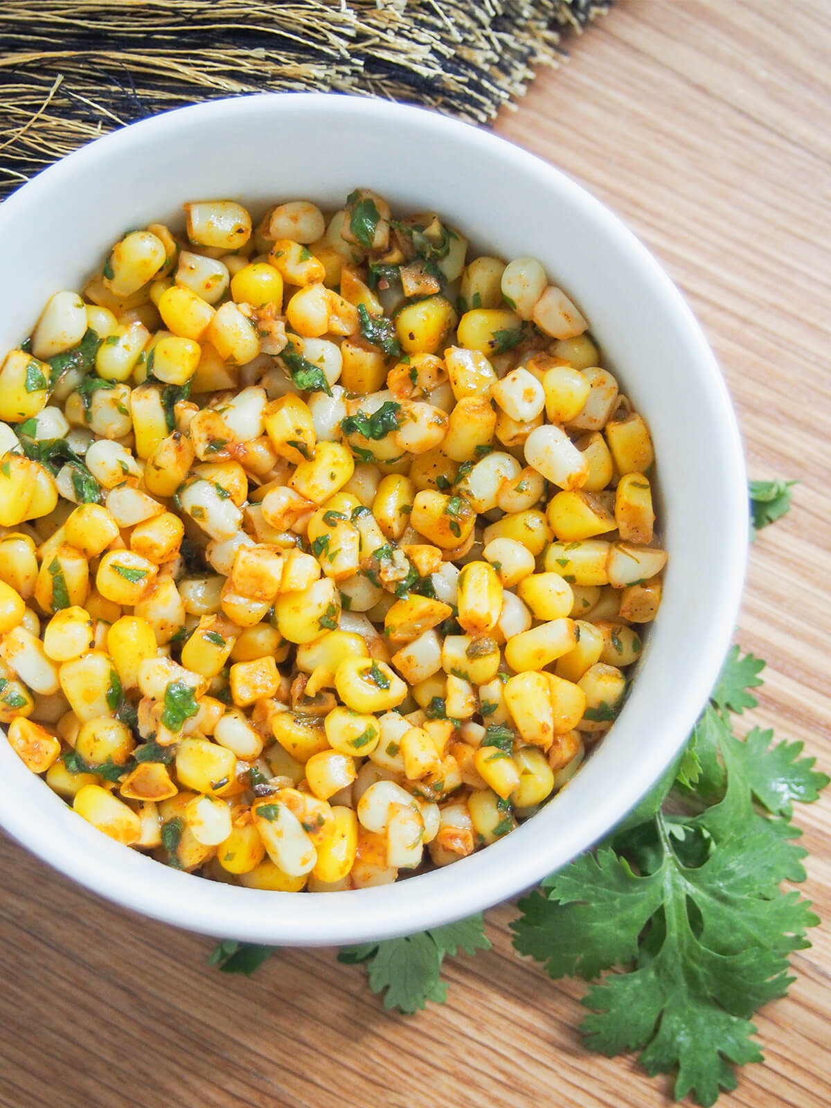 close up overhead view of a bowl of masala corn.