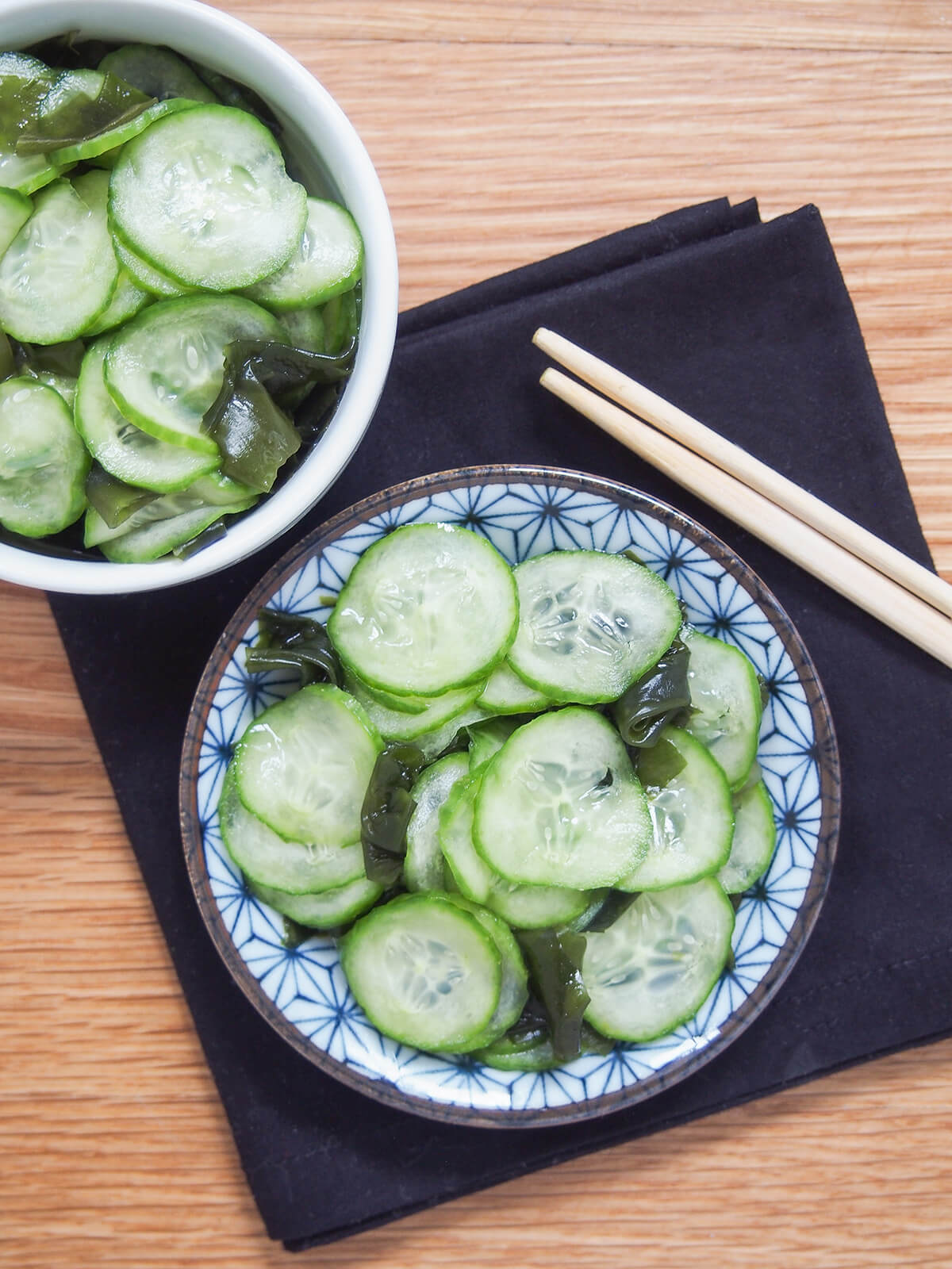 overhead view of dishes with Japanese cucumber salad, sunomono.