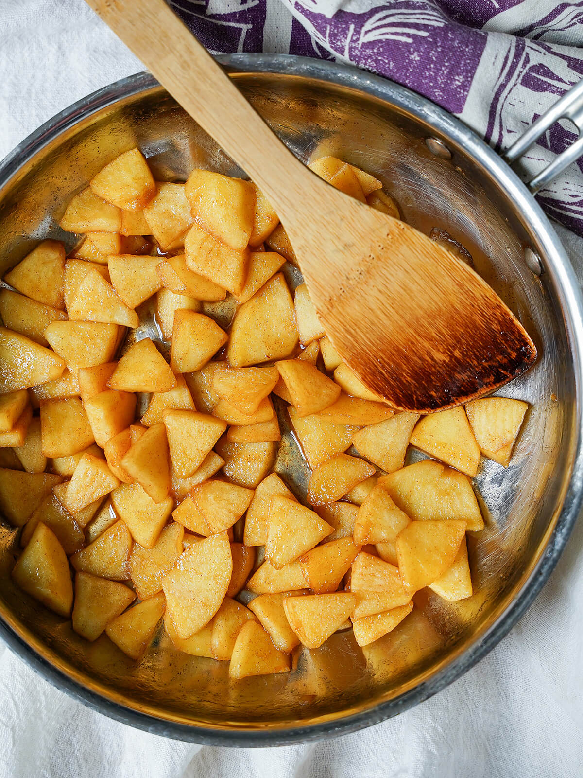 skillet full of caramelized apples overhead view of a skillet full of caramelized apples