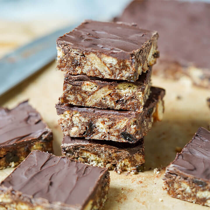 stack of chocolate tiffin with pieces blurred around.