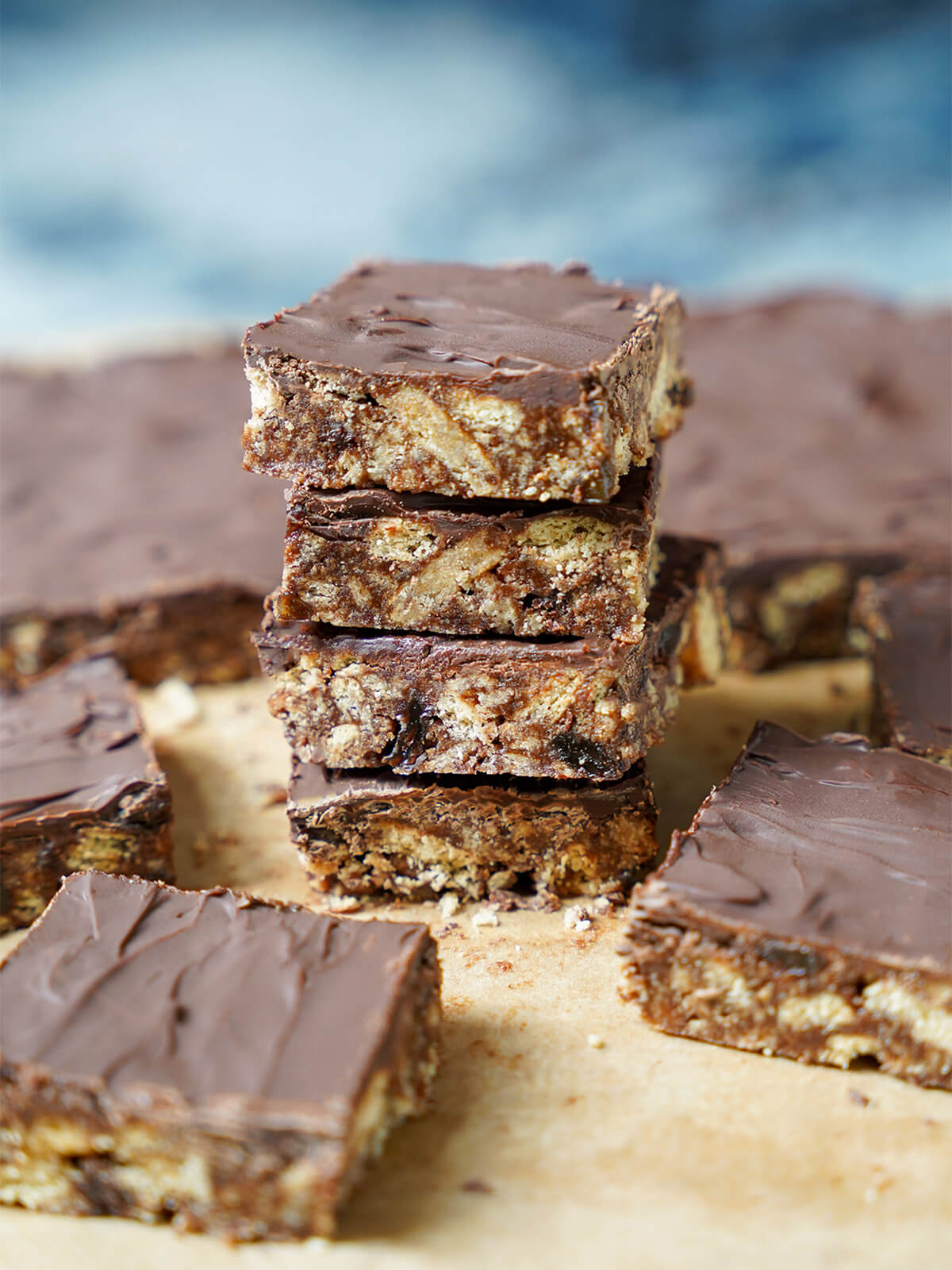 stack pf chocolate tiffin with other pieces either side and uncut block behind.