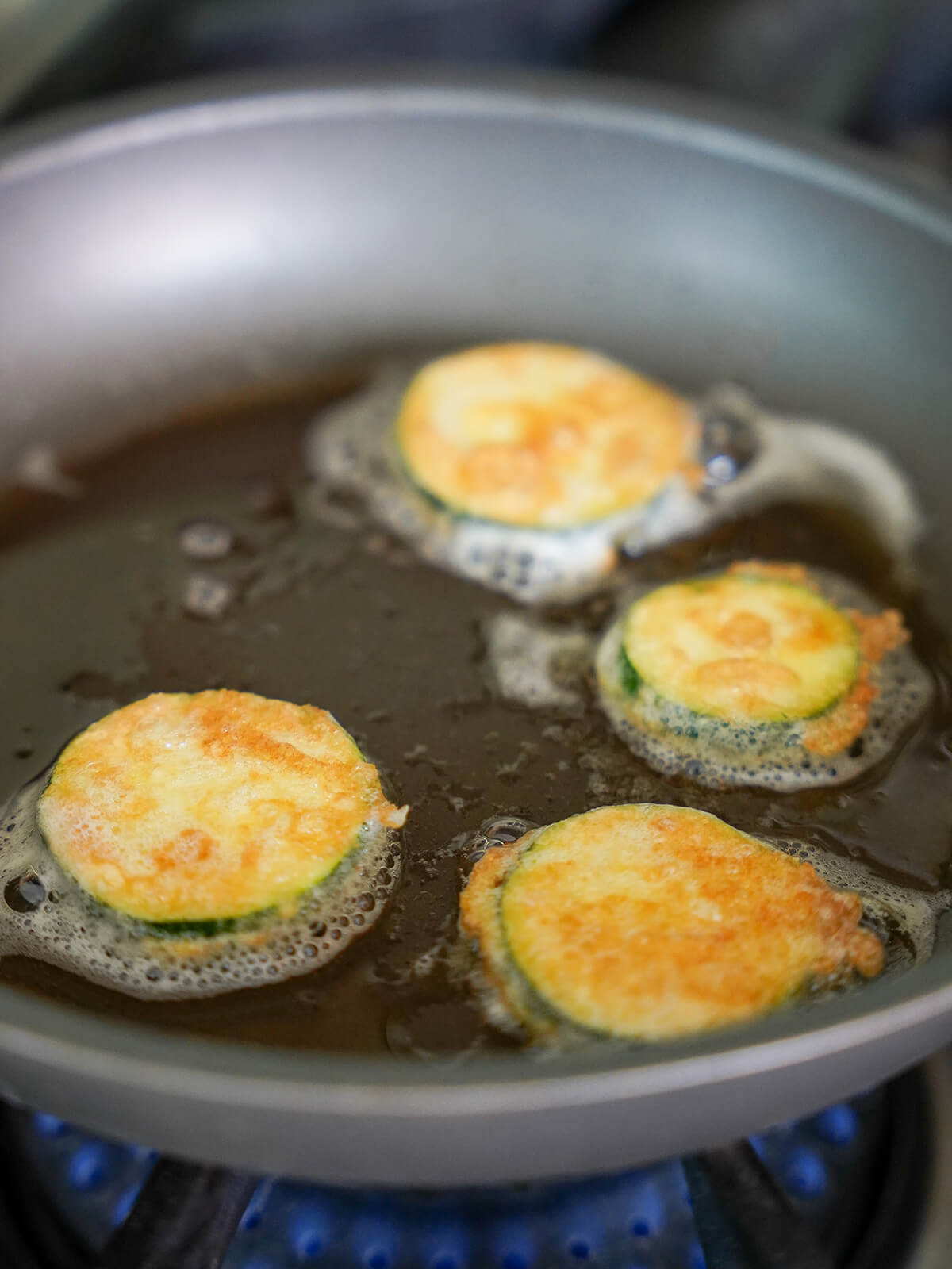 frying Korean zucchini fritters, hobak jeon in skillet