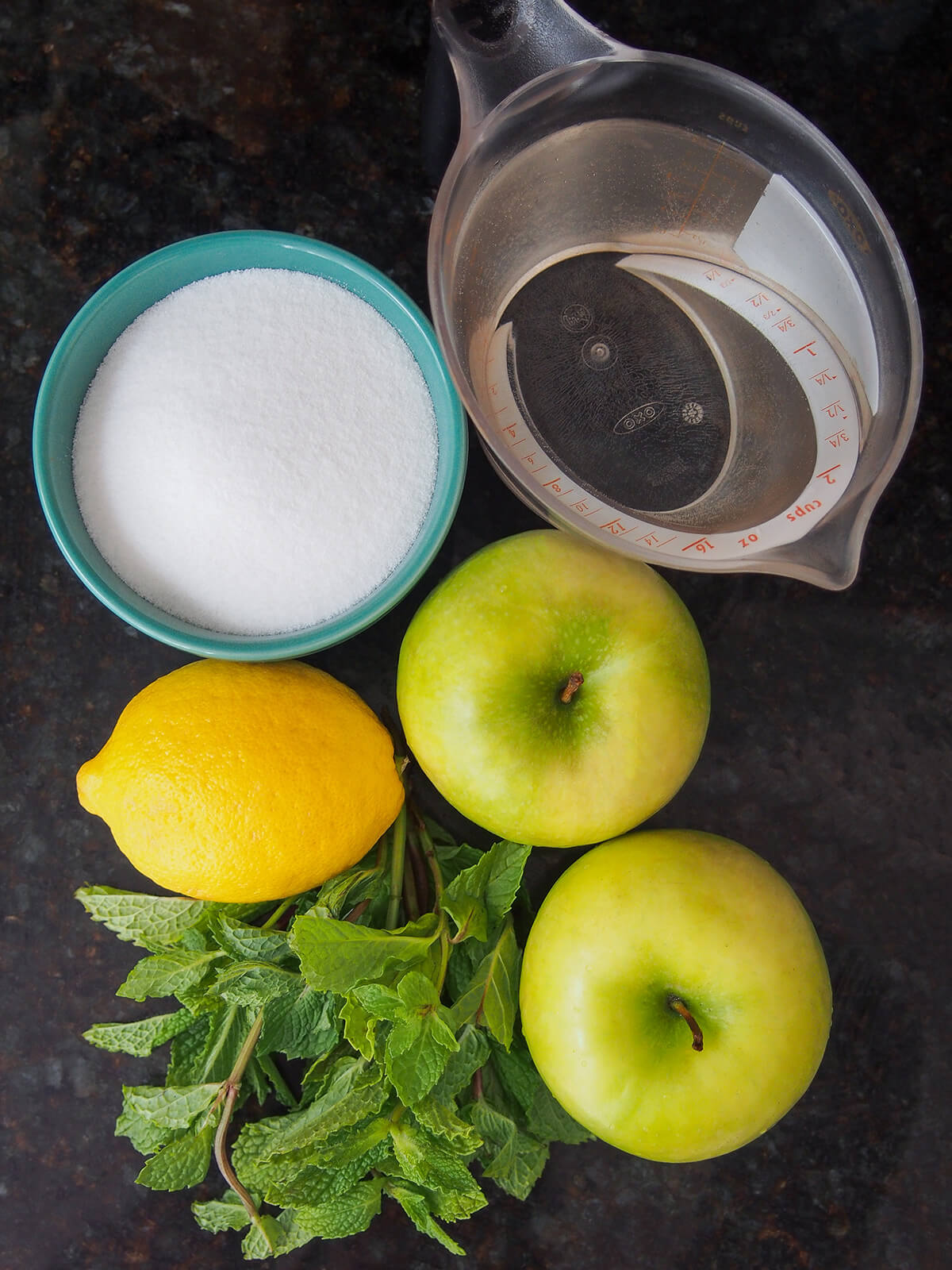 bowl of sugar, measure of water, green apples, lemon and big bunch of mint.