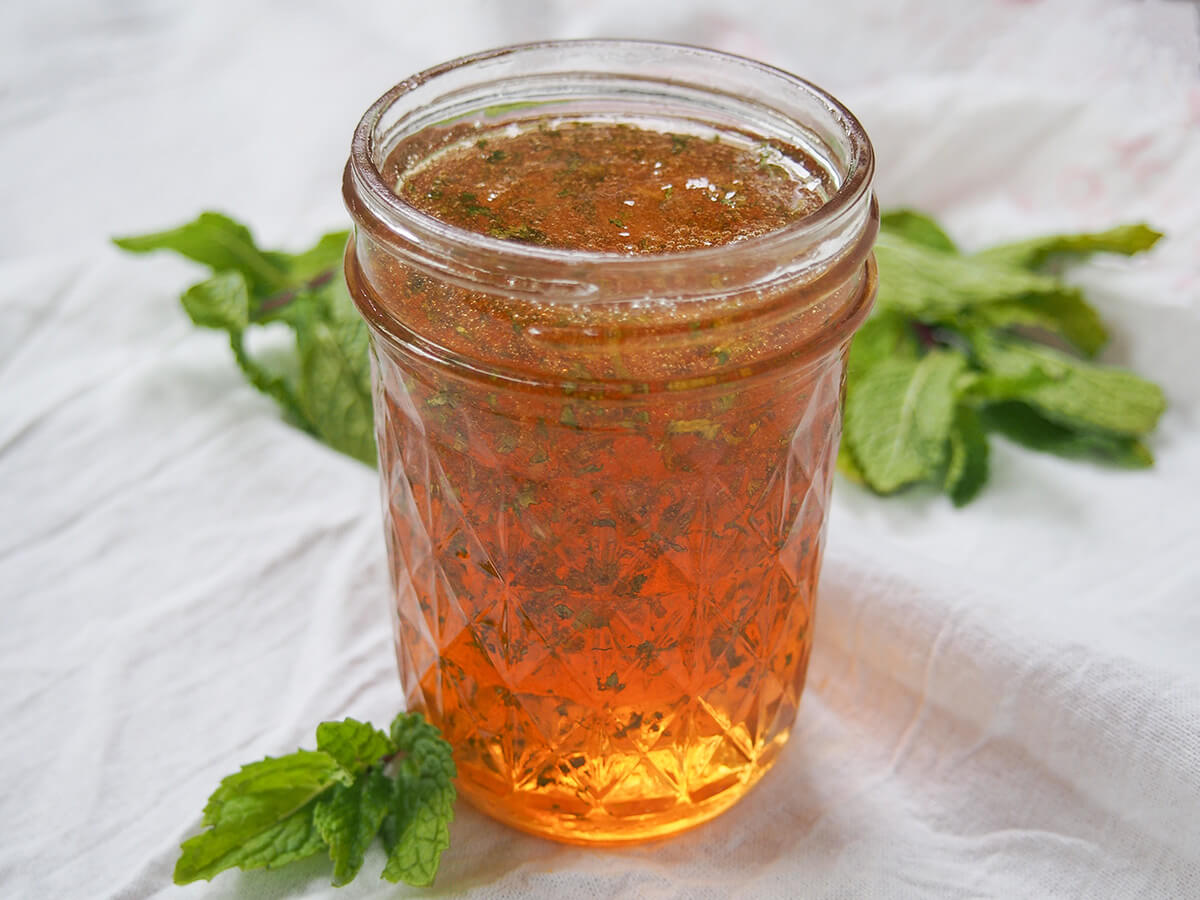 side view of jar of mint jelly.