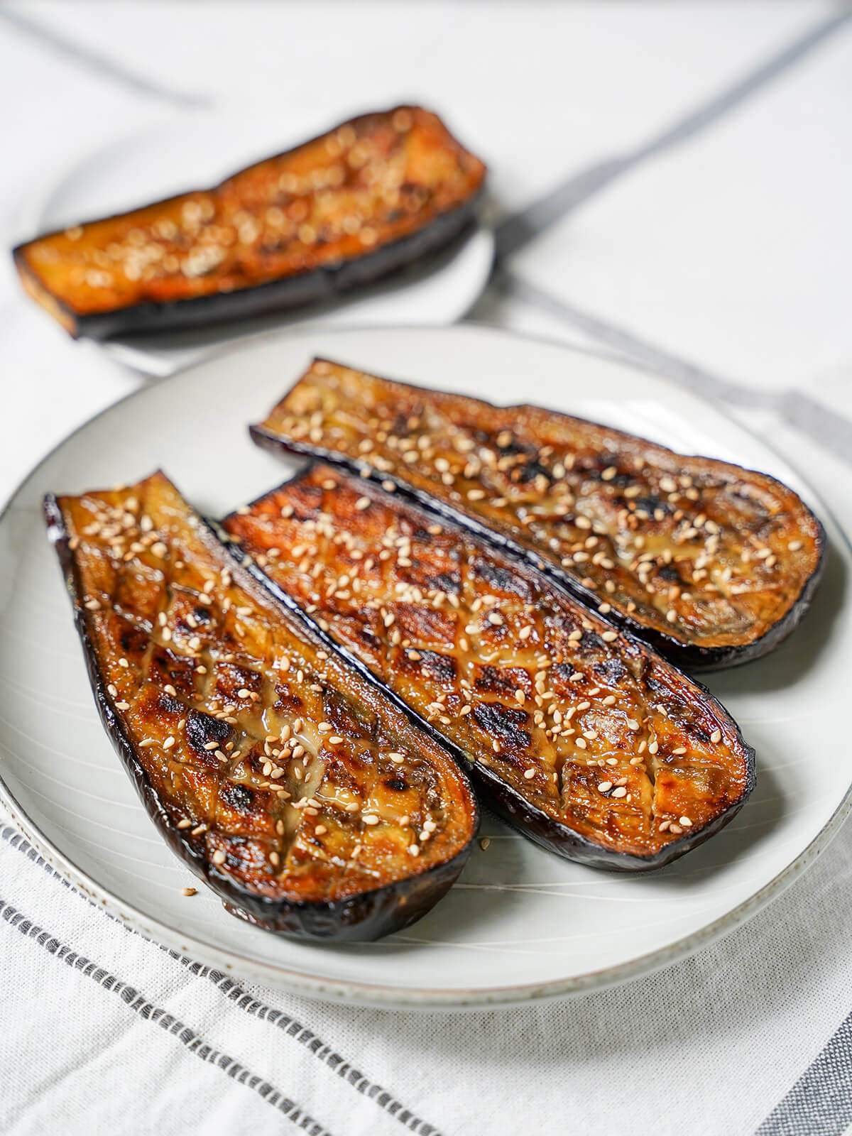 plate of three pieces of miso glazed eggplant, nasu dengaku.