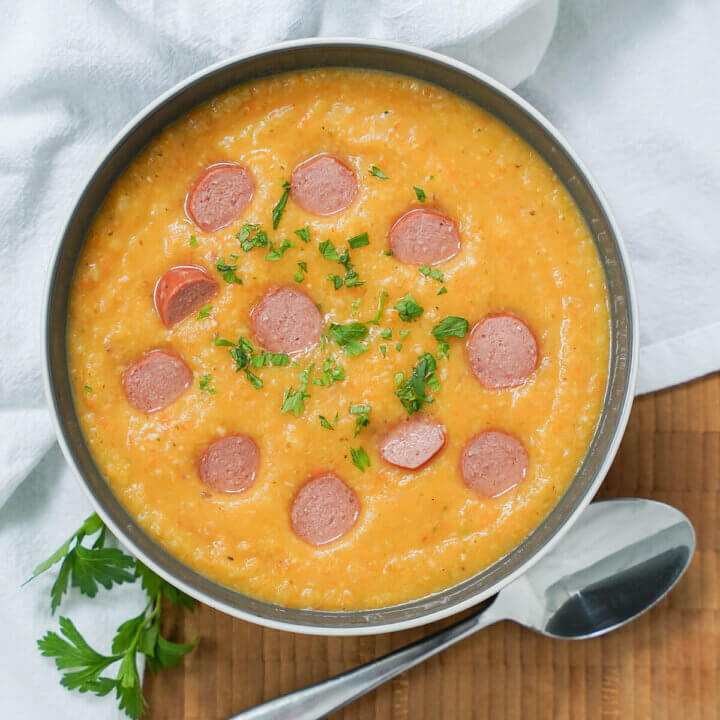 bowl of German potato soup, kartoffelsuppe, with spoon below bowl.