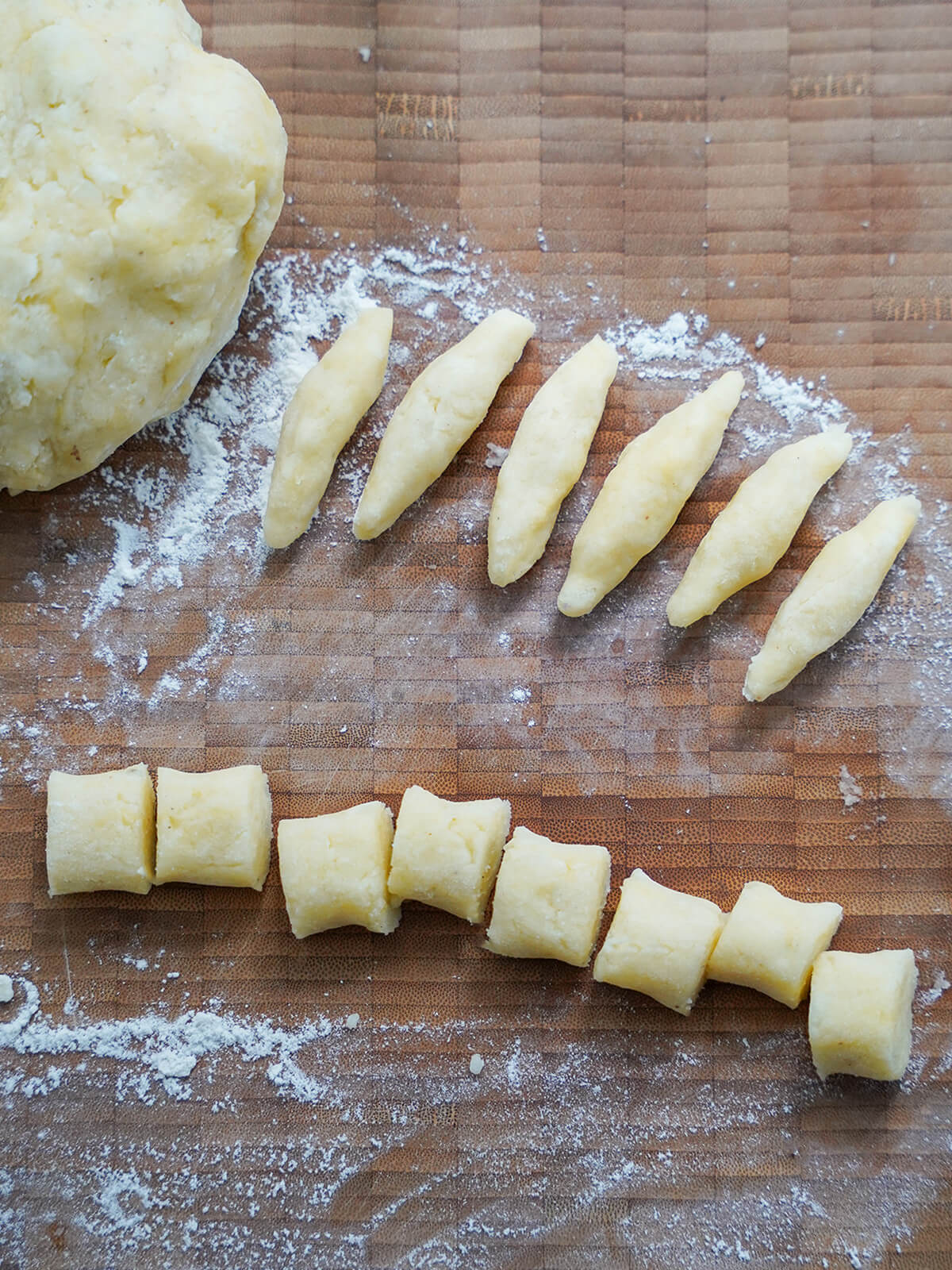 ball of dough, some pieces cut into sections and some formed into finger-like shapes.